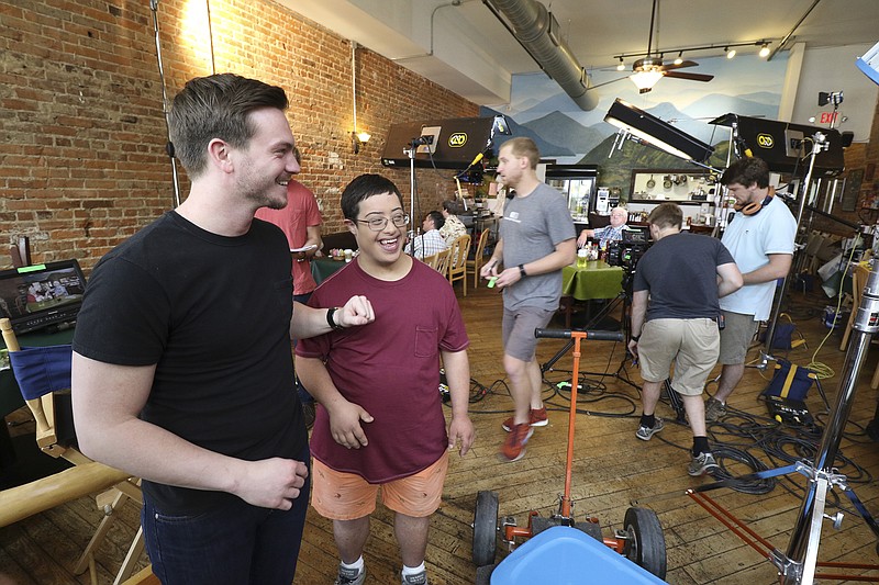 Chris McNelly and Andrew Ankar joke around while on the set of a television comedy pilot named "Mac & Drew" that is being filmed at the Bluegrass Grille off of Main Street.