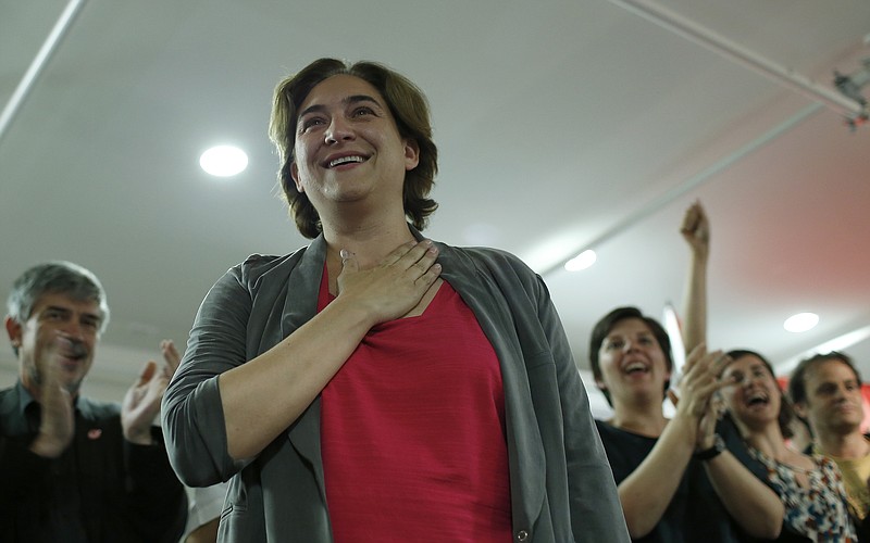 
              The leader of leftist coalition Barcelona Together, Ada Colau, foreground celebrates the victory of her party after elections in Barcelona, Spain, Sunday, May 24, 2015. New parties won strong support in Spain's local elections Sunday as voters turned their back on the country's traditional political heavyweights, an exit poll indicated. There was also an upset in Barcelona, where a popular anti-eviction campaigner backed by We Can was poised to unseat the region's long dominant and conservative Convergence and Union party. (AP Photo/Manu Fernandez)
            