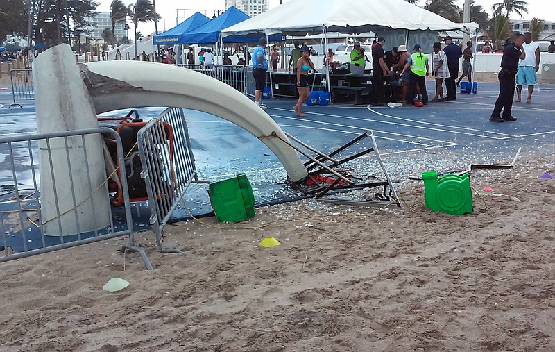 
              In this photo provided by Burt Osteen, glass is scattered around a toppled basketball hoop after a waterspout made landfall at Fort Lauderdale Beach, Fla. on Monday, May 25, 2015. Authorities say three children were injured when the waterspout uprooted a bounce house and sent it across a parking lot into the road. (Burt Osteen via AP)
            