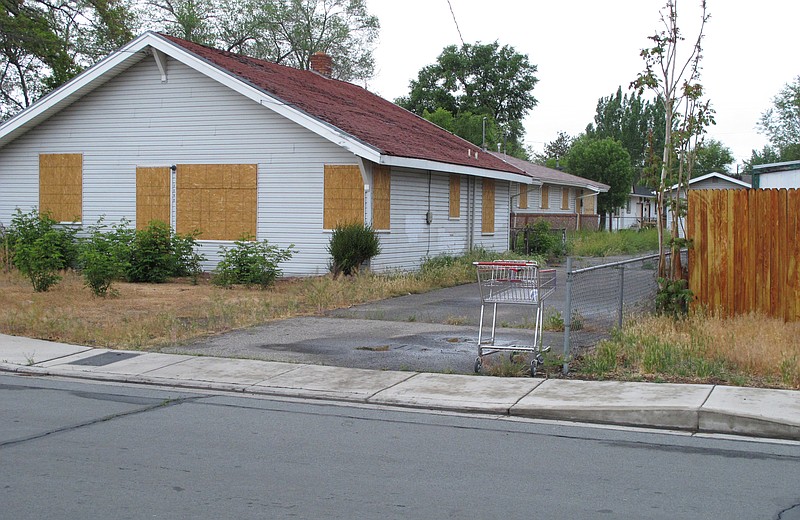 
              FILE - This May 15, 2015, file photo, shows the boarded duplex where Wayne Burgarello fatally shot an unarmed trespasser in February 2014, in Sparks, Nev. Burgarello now faces murder charges. The case has helped renew discussions about stand-your-ground laws and how they are interpreted across the U.S. (AP Photo/Scott Sonner, File)
            