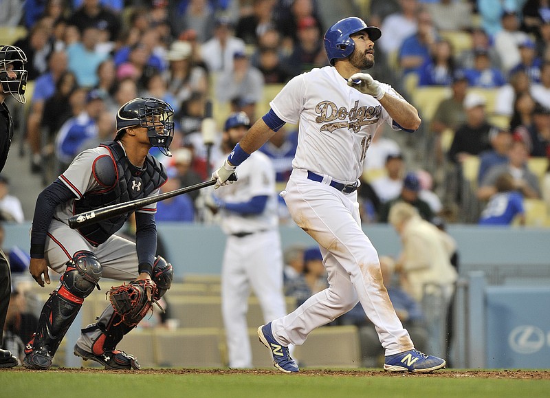 Los Angeles Dodgers Andre Ethier, right, hits a home run as Atlanta Braves catcher Christian Bethancourt looks on during the eighth inning of a baseball game in Los Angeles on Monday, May 25, 2015.