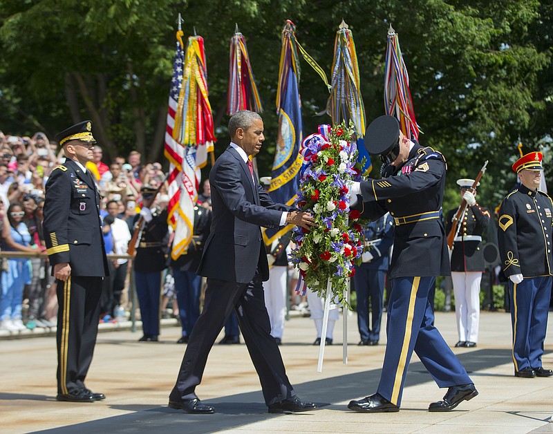 
              President Barack Obama, accompanied by Maj. Gen. Jeffrey S. Buchanan, left, Commander of the U.S. Army Military District of Washington, and the with the aid of  Sgt. 1st Class John C. Wirth, lays a wreath at the Tomb of the Unknowns, on Memorial Day, Monday, May 25, 2015, at Arlington National Cemetery in Arlington, Va.  (AP Photo/Pablo Martinez Monsivais)
            