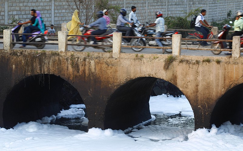 
              In this Monday, May 25, 2015, file photo, traffic moves on a bridge over Bellundur Lake which is filled with froth from industrial pollution in Bangalore, India, Monday, May 25, 2015. Indian prime minister Narendra Modi’s first year in office was punctuated with promises of clear rivers, clean energy and toilets for all, but environmentalists worry his government is on an entirely different path: dismantling hard-won environmental laws in the name of boosting growth. (AP Photo/Aijaz Rahi)
            