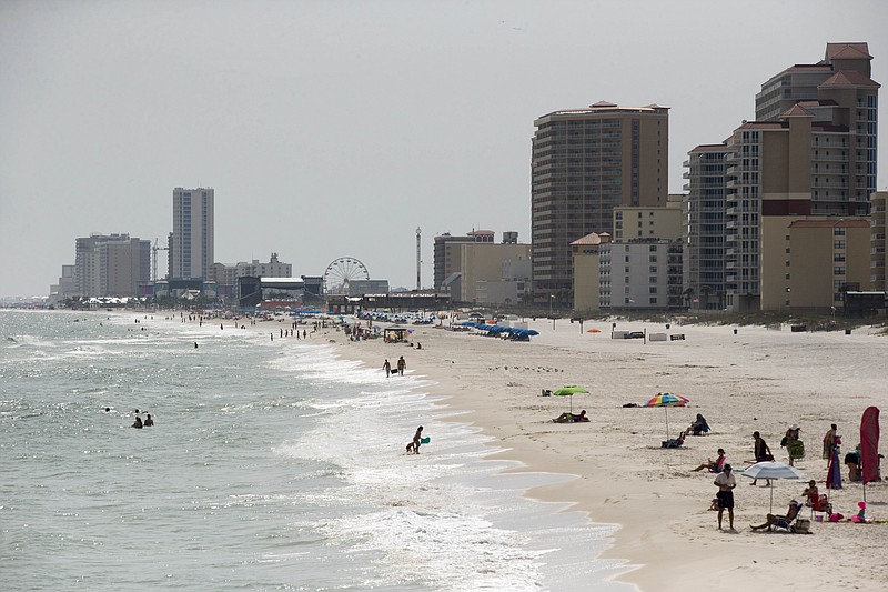 In this Wednesday, May 13, 2015, photo, tourists line the beaches in Gulf Shores, Ala. Industry officials say Gulf Coast tourism is surging, five years after the BP oil spill.