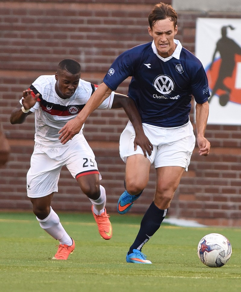 Chattanooga Football Club's Sias Reyneke and Atlanta Silverbacks' Ferrety Sousa chase the ball Wednesday at Finley Stadium.