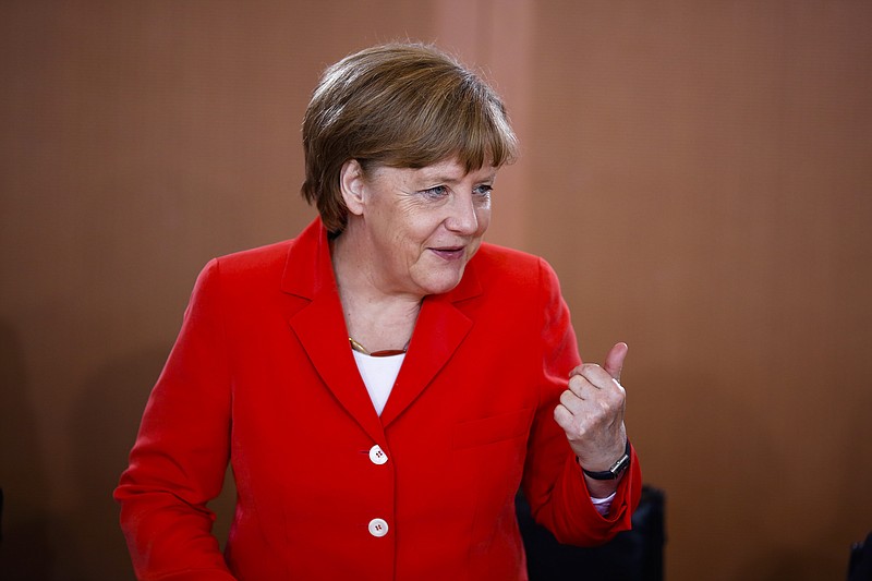 
              German Chancellor Angela Merkel talks to cabinet members as she arrives for the weekly cabinet meeting at the chancellery in Berlin, Germany, Wednesday, May 27, 2015. (AP Photo/Markus Schreiber)
            