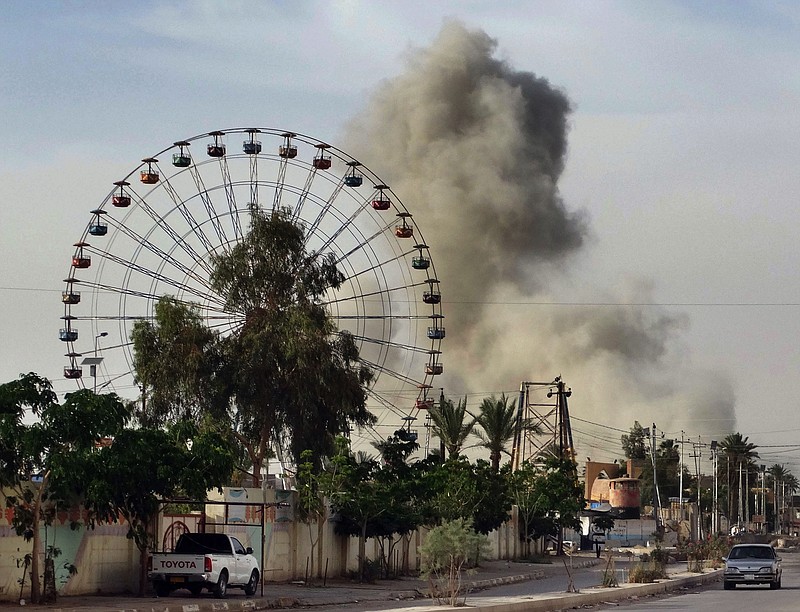 
              FILE - In this Saturday, May 9, 2015 file photo, a plume of smoke rises after an airstrike by the U.S.-led coalition against Islamic State group positions in an eastern neighborhood of Ramadi, the capital of Anbar province, 70 miles (115 kilometers) west of Baghdad, Iraq. The U.S.-led coalition has carried out over 4,100 airstrikes against Islamic State radicals, with limited results. (AP Photo, File)
            