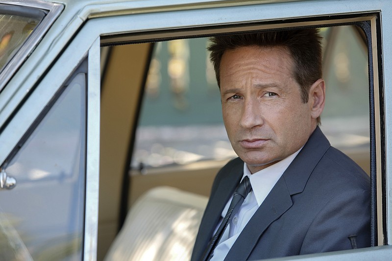 
              This photo provided by NBC shows David Duchovny as Sam Hodiak in a scene from the episode, "Home is Where You're Happy," from the new NBC television series, "Aquarius." Duchovny plays a Los Angeles police detective working a case involving Charles Manson which premieres Thursday, May 28, 2015, at 9 p.m. EDT. (Vivian Zink/NBC via AP)
            