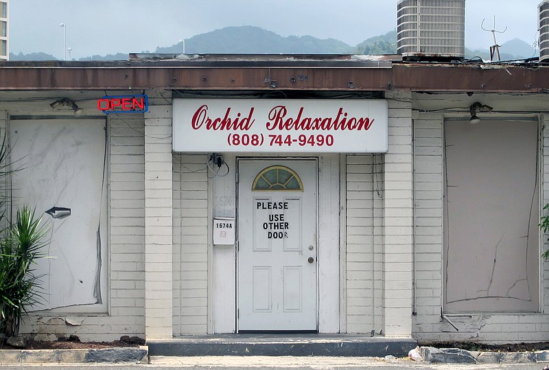 
              FILE - This May 6, 2015 file photo shows an open sign hanging outside Orchid Relaxation in Honolulu. The massage parlor was one of several local businesses that were targeted in a police prostitution sting. Honolulu’s top prosecutor is dismissing sex assault charges against 16 women arrested in the massage parlor prostitution sting. Prosecuting Attorney Keith Kaneshiro said Wednesday, May 27, the allegations might have constituted a technical violation of law, but proof beyond a reasonable doubt couldn’t be established. (AP Photo/Jennifer Sinco Kelleher,File)
            