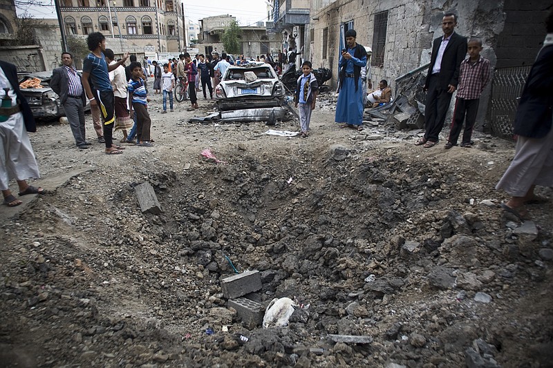 
              People stand around a crater made by a Saudi-led coalition airstrike in Sanaa, Yemen, Wednesday, May 27, 2015. In a new report Wednesday, World Health Organization Chief Margaret Chan said that Yemen's conflict has left up to 2,000 people dead and 8,000 wounded, including hundreds of women and children. She did not specify how many of the dead were civilian. (AP Photo/Hani Mohammed)
            