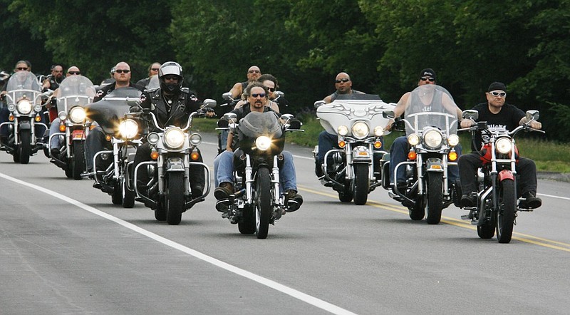 Members of the Outlaws motorcycle club, joined by members from other clubs, ride through Hollis Center, Maine Saturday, June 26, 2010. Club members gathered for a memorial service for Thomas Mayne, a club leader who was killed during a shootout with federal agents. Mayne was killed June 15 after ATF agents tried to arrest him in his home in Old Orchard Beach, Maine. 