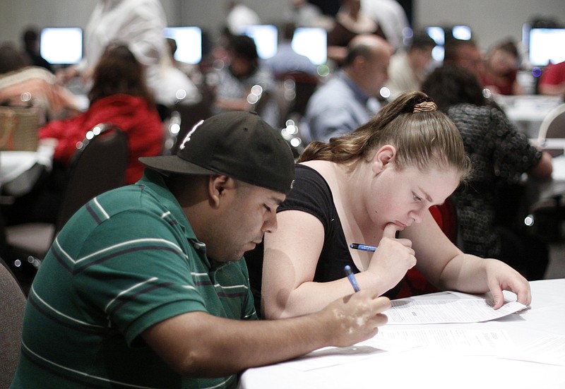 Jorge Morales, 23, and Karina Ross, 20, join hundreds of other hopefuls at the Northwest Georgia Trade and Convention Center in Dalton, Ga., to apply for new jobs in this file photo.