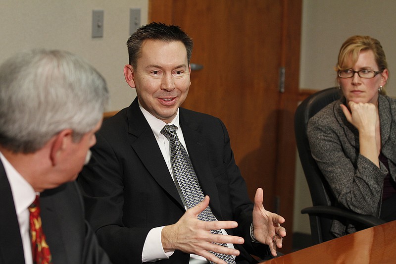 Robert Sharpe, center, details the educational benefits of a one-to-one ratio between students and technology, while Rick Smith, left, and Tracey Carisch, right, listen during a meeting with Times Free Press reporters in 2012.