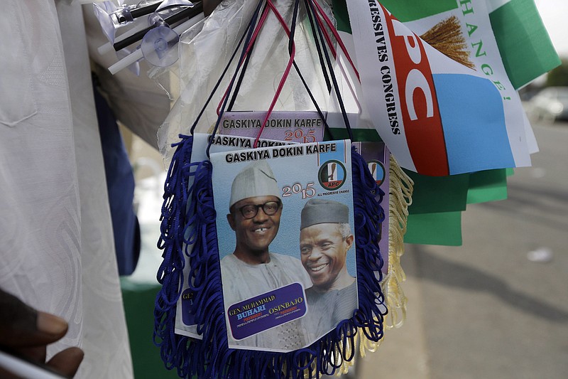 
              A man sells banners of former General and Nigerian President elect, Muhammadu Buhari, and Vice President elect Yemi Osibajo, outside Eagle Square, a day ahead of the Presidential Inauguration of Buhari, in Abuja,  Nigeria, Thursday, May 28, 2015. (AP Photo/Sunday Alamba)
            