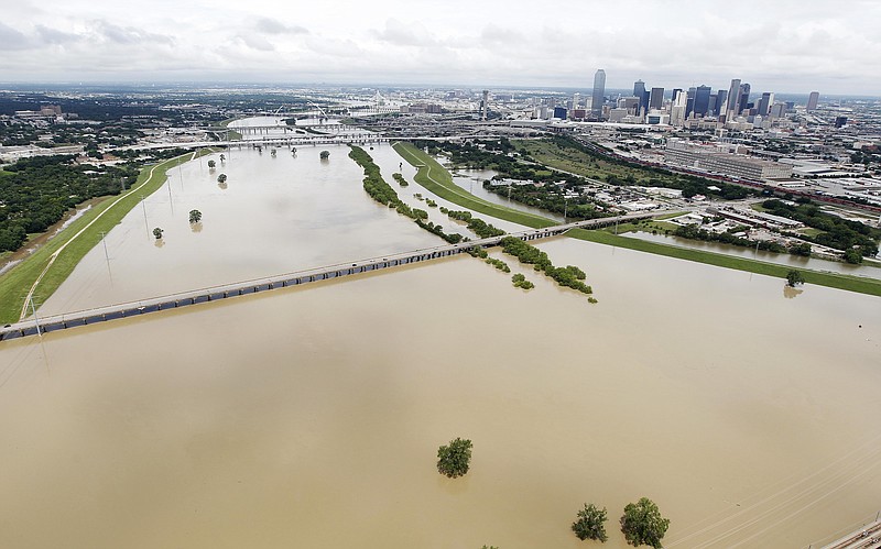 
              A swollen Trinity River southwest of downtown Dallas, Friday, May 29, 2015. Floodwaters submerged Texas highways and threatened more homes Friday after another round of heavy rain added to the damage inflicted by storms. (AP Photo/Brandon Wade)
            