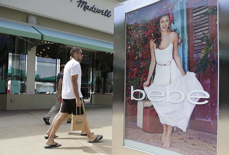 
              FILE - In this March 13, 2015 file photo, shoppers walk past an advertisement for retailer "bebe" along Lincoln Road Mall, a pedestrian street featuring retail stores and outdoor cafes, in Miami Beach, Fla. The University of Michigan issues its monthly index of consumer sentiment for May on Friday, May 29, 2015. (AP Photo/Lynne Sladky, File)
            