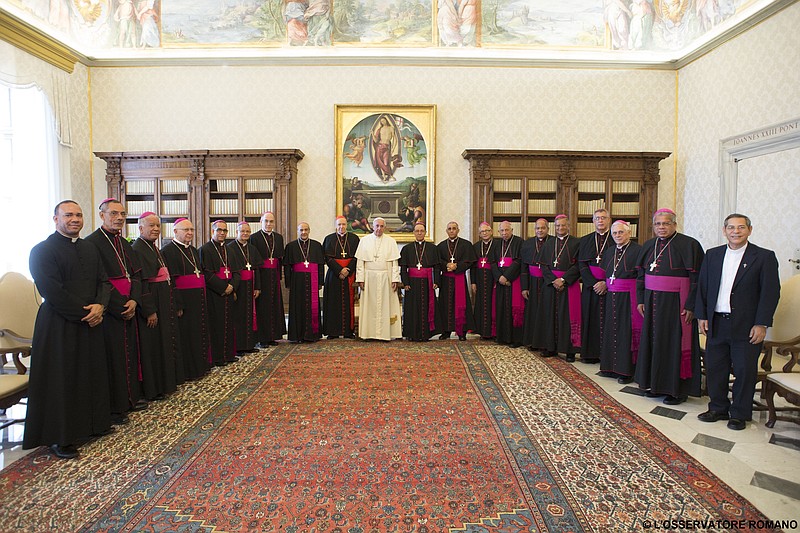 
              Pope Francis poses for photographers with members of Dominican Republic Episcopal Conference in the pontiff's private studio at the Vatican, Thursday, May 28, 2015. (L'Osservatore Romano/Pool Photo via AP)
            