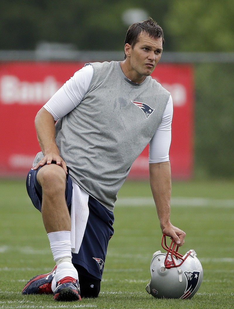 
              New England Patriots quarterback Tom Brady, right, takes a break during an NFL football organized team activity Friday, May 29, 2015, in Foxborough, Mass. (AP Photo/Elise Amendola)
            