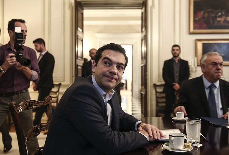 
              Greece's Prime Minister Alexis Tsipras, center, looks on during a meeting with Iranian Foreign Minister Mohammad Javad Zarif in Athens, Greece, on Thursday, May 28, 2015. Greece says it aims to clinch a deal with its creditors by Sunday, a development that would allow it to receive the desperately needed final installment of its international bailout plan and prevent a default.  (AP Photo/Yorgos Karahalis)
            