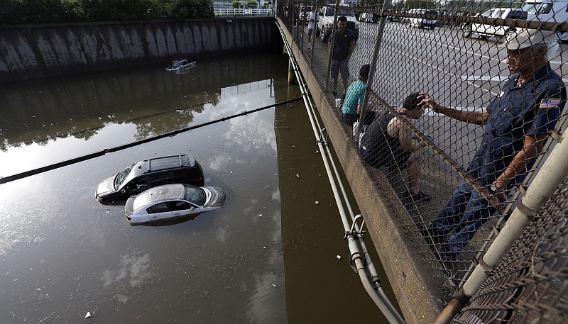 
              FILE - In this May 29, 2015 file photo, cars sit in floodwaters along Interstate 45 after heavy overnight rain flooded parts of the highway in Houston. Even for a world getting used to wild weather, May seems stuck on strange. Torrential downpours in Texas, whiplashing the region from drought to flooding. A heatwave that has already killed more than 1800 in India and is the fifth deadliest since 1900. Record 91 degree temperature in of all places Alaska. A pair of top-of-the-scale typhoons in the Northwest Pacific.  And a drought in the U.S. East is starting to take root just as the one ends in Texas. (AP Photo/David J. Phillip, File)
            