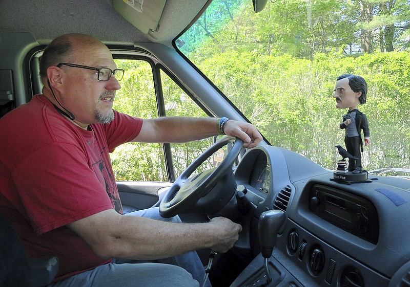 
              In this Thursday, May 28, 2015 photo, an Edgar Allan Poe bobble-head rests on the dashboard of a utility van dubbed "Dedgar the Poemobile," driven by its owner, Dead Poets Society of America founder Walter Skold, left, in Freeport, Maine. Skold will take the van on a 16-state, 10-week tour to document the final resting places of 90 poets in the Deep South. (AP Photo/David Sharp)
            