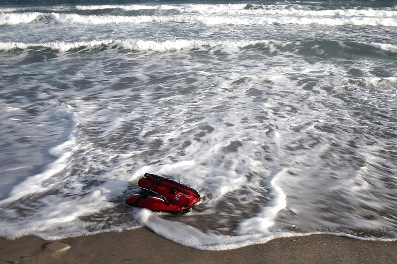 
              A life vest worn by one of six migrants who crossed from Turkey to Greece with an inflatable boat floats on the shore of Kos island, Greece, early Saturday, May 30, 2015. Greece and Italy are the main points of entry into the European Union for refugees and economic migrants from the Middle East and Africa hoping to reach other European Union countries. According to government estimates, some 37,500 immigrants and asylum seekers have reached Greece illegally so far this year. (AP Photo/Petros Giannakouris)
            