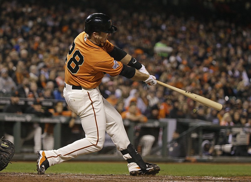 San Francisco Giants' Buster Posey hits an RBI double off Atlanta Braves relief pitcher Jim Johnson in the eighth inning of a baseball game Friday, May 29, 2015, in San Francisco.