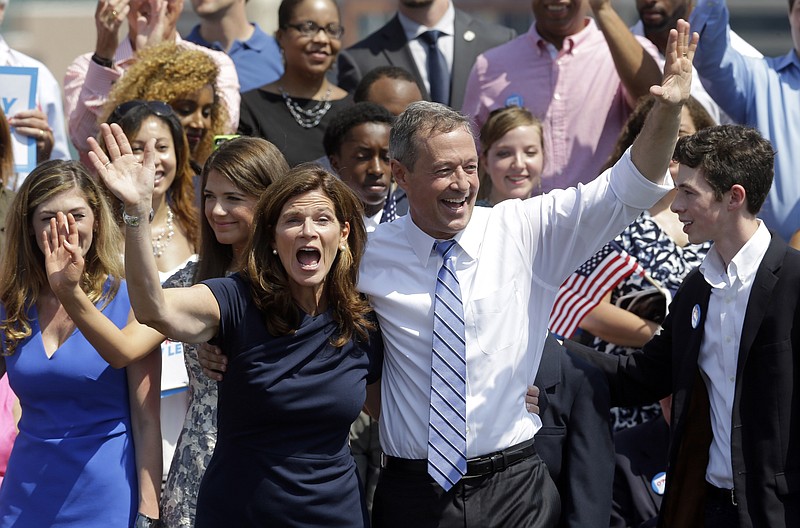 
              Former Maryland Gov. Martin O'Malley, right, and his wife Katie wave to supporters during an event to announce that he is entering the Democratic presidential race, Saturday, May 30, 2015, in Baltimore.   O'Malley joined the Democratic presidential race with a longshot challenge to Hillary Rodham Clinton for the 2016 nomination.  "I'm running for you," he told a crowd of about 1,000 people at Federal Hill Park in Baltimore, where he served as mayor before two terms as governor.   (AP Photo/Patrick Semansky)
            