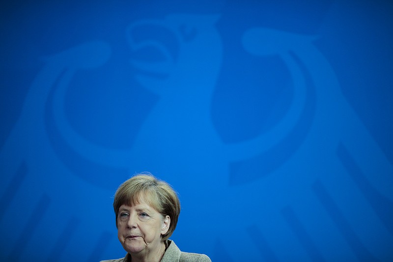 
              German Chancellor Angela Merkel briefs the media during a news conference with British Prime Minister David Cameron after meeting at the chancellery in Berlin, Germany, Friday, May 29, 2015.  (AP Photo/Markus Schreiber)
            