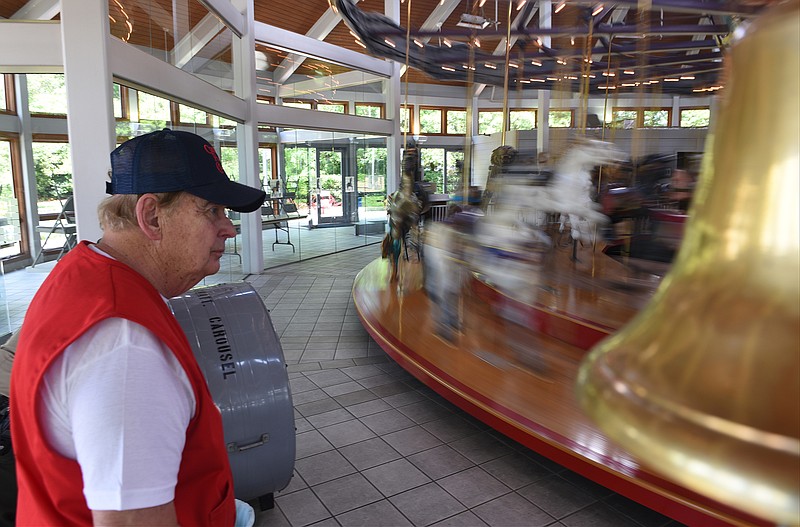 Coolidge Park Carousel attendant Bud Jones works at the popular vintage attraction recently.