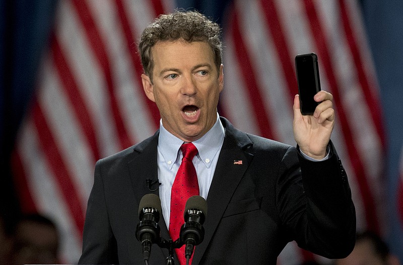 In this April 7, 2015, file photo, Sen. Rand Paul, R-Ky. holds up his cell phone as he speaks before announcing the start of his presidential campaign, in Louisville, Ky.