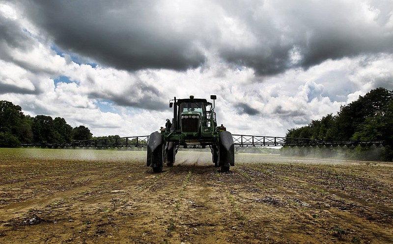 Mississippi farmer Pat Woods' 1080 acres of cotton rows are sprayed with a blend of herbicides, near Byhalia Friday afternoon. Woods' cotton plants are running roughly two weeks behind schedule due to saturated fields. In Mississippi, like several other southern states, the decline of cotton farms has reached an all-time low, with the fewest number of acres planted since the Civil War.