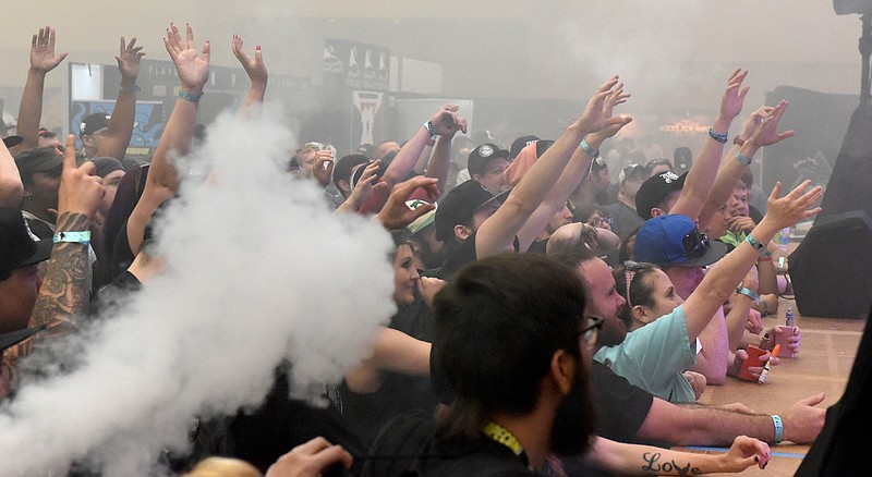 Attendees reach for prizes thrown from the stage during Vapecon at the Chattanooga Convention Center on Sunday Chattanooga.