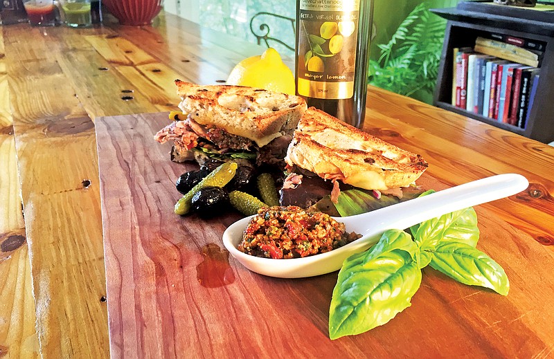 Pesto made with fresh herbs, garlic and sun-dried tomatoes is a tasty and versatile way to spice up everything from pasta to sandwiches. Above, it's spread on toasted olive bread along with Italian beef, lettuce and cheese.