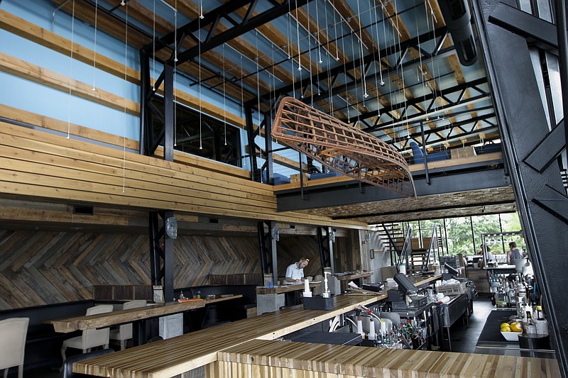 A decorative canoe hangs above the bar of the Flying Squirrel on Tuesday, June 2, 2015, in Chattanooga. The Flying Squirrel was recently voted the best-designed cafe and bar in the Restaurant Design Awards.