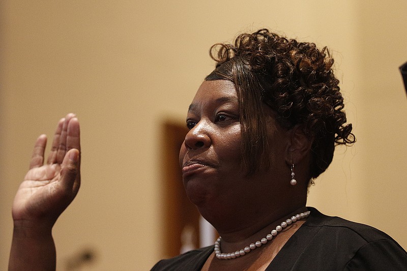 Dr. Elenora Woods raises her hand to be sworn in as the new president along with other officers during the Chattanooga-Hamilton County NAACP's Jubilee Day Celebration on Thursday, Jan. 1, 2015, at First Baptist Church of Chattanooga in Chattanooga