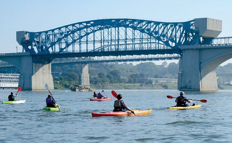 Competitors head toward the Market Street Bridge during the RiverRocks canoe and kayak races in 2013.