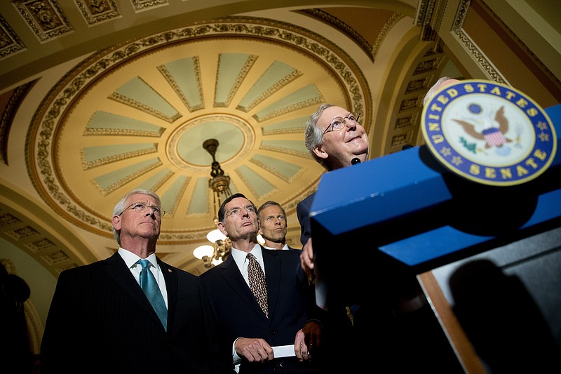 Senate Majority Leader Mitch McConnell of Ky., right, accompanied by, from left, Sen. Roger Wicker, R-Miss., Sen. John Barrasso, R-Wyo., and Sen. John Thune, R-S.D., speaks during a news conference on Capitol Hill in Washington on June 2, 2015.