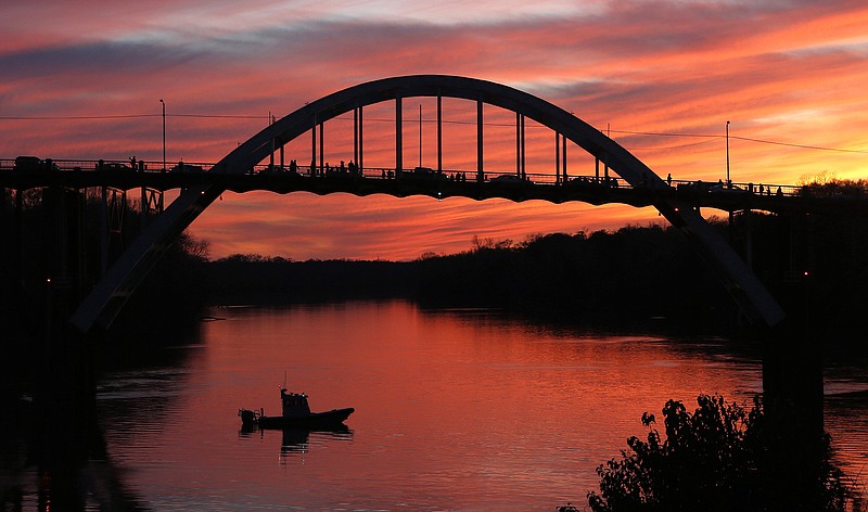 In this Friday, March. 6, 2015, file photo, the sun sets over the Edmund Pettus Bridge in Selma, Ala. Alabama senators on Wednesday, June 3 approved a resolution to rename the bridge the Journey to Freedom Bridge.