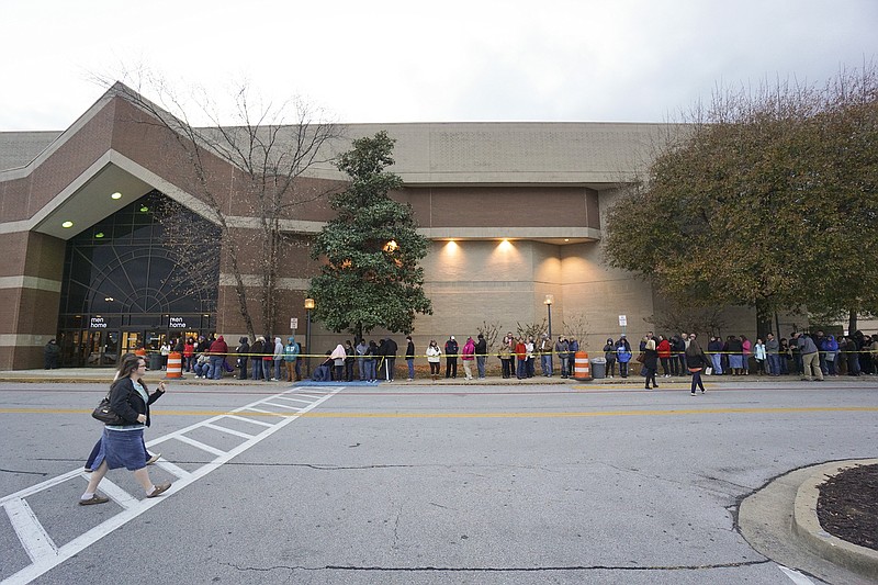 Shoppers line up for special "Black Friday" deals Thanksgiving evening at the Hamilton Place Mall Belk on Thursday, Nov. 27, 2014.