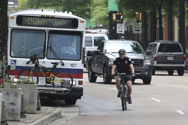 Chattanooga Police Officer Rob Simmons patrols Market Street on Wednesday, June 3, 2015 while using a brand-new device attached to his bicycle that measures the distance motorists give when passing. 