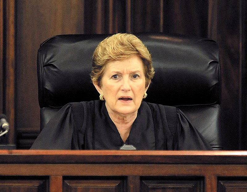 
              Former Glynn County Superior Court judge Amanda F. Williams sits on the bench in this undated photo in Brunswick, Ga. Williams served 20 years until she resigned from office in January 2012 to settle non-criminal misconduct charges. More than three years later, Williams was indicted by a grand jury on Wednesday, June 3, 2015, on charges that she lied to investigators in the prior misconduct case. (AP Photo/The Brunswick News, Bobby Haven)
            
