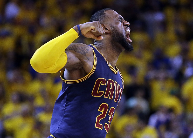 
              Cleveland Cavaliers forward LeBron James (23) celebrates after end of the overtime period of Game 2 of basketball's NBA Finals against the Golden State Warriors in Oakland, Calif., Sunday, June 7, 2015. The Cavaliers won 95-93 in overtime. (AP Photo/Ben Margot)
            