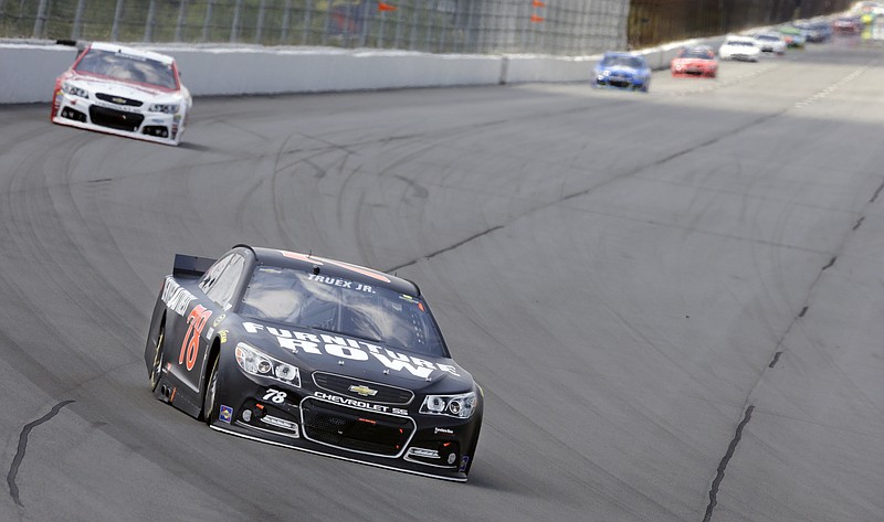 Martin Truex Jr. (78) leads Kevin Harvick (4) through turn one during his race at Pocono Raceway in Long Pond, Pa., Sunday, June 7, 2015.