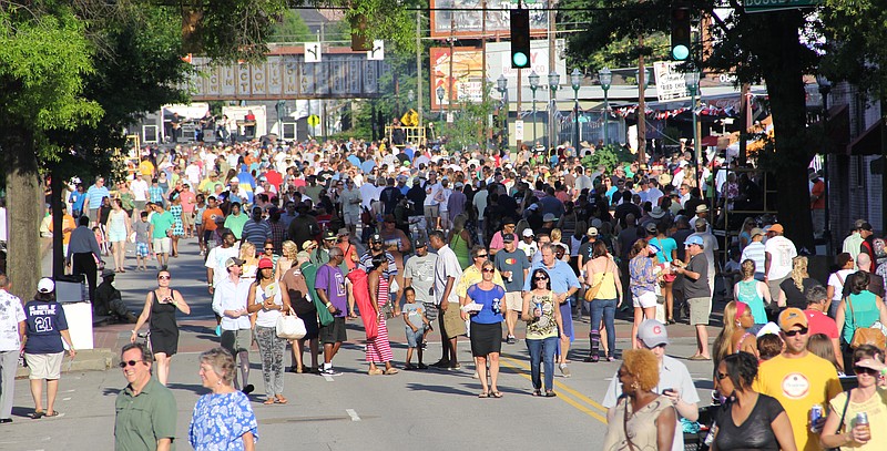 Festivalgoers crowd M.L. King Boulevard during the Bessie Smith Strut in 2014.