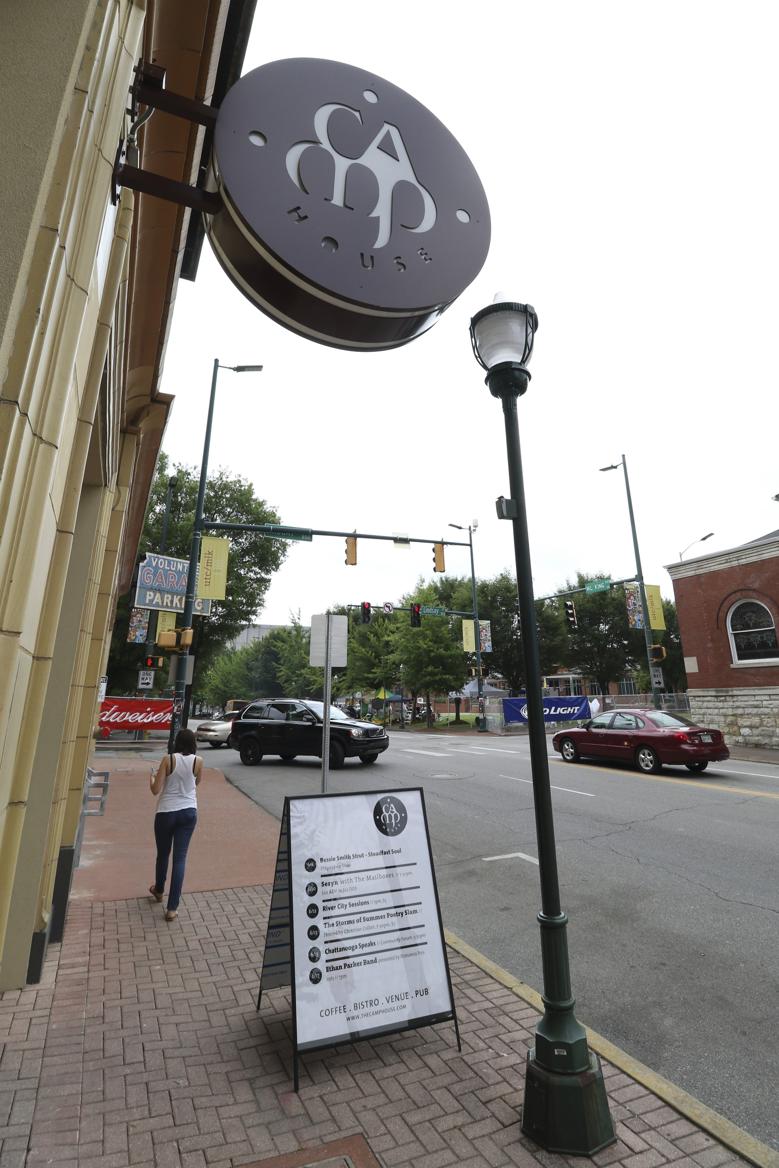 Motorists drive along M.L. King Boulevard past the Camp House.