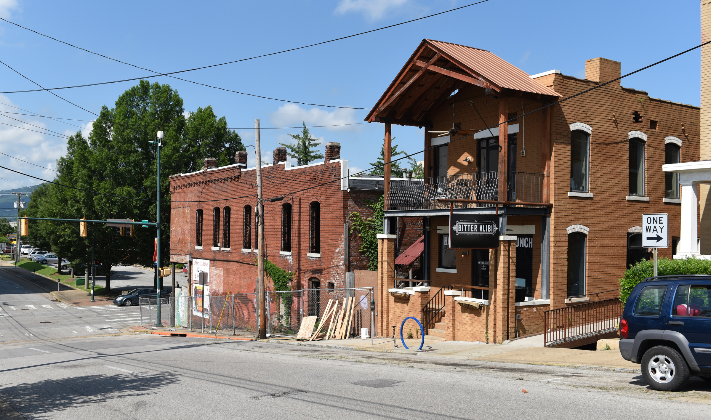 The building on M.L. King Boulevard and Houston Street is seen at left next to the Bitter Alibi.