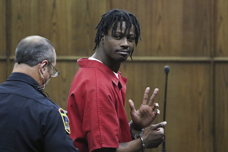 Ronald Cosper waves to family after appearing before Judge Barry Steelman on June 8, 2015 for sentencing on additional charges of attempted especially aggravated robbery, adding to his first-degree felony murder sentence of life in prison in the 2012 killing of Steve Mosley.