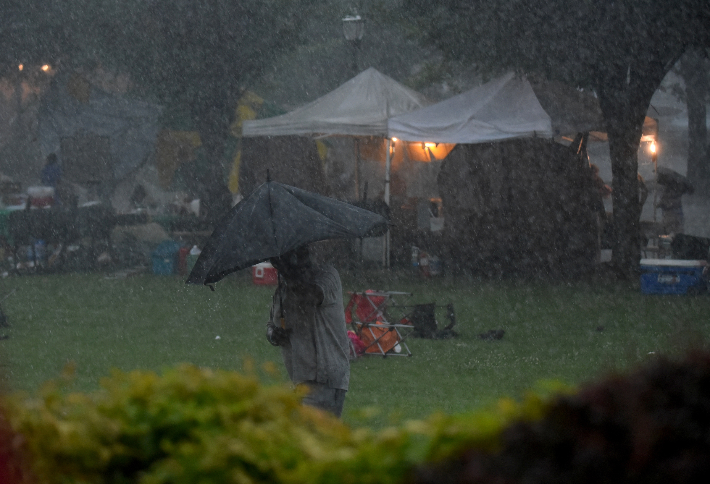 Staff Photo by Angela Lewis Foster/ The Chattanooga Times Free Press- 6/08/15
A man carries an umbrella through the lawn of the Bessie Smith Cultural Center as a torrential downpour brings the music to a stop Monday at the Bessie Smith Strut.