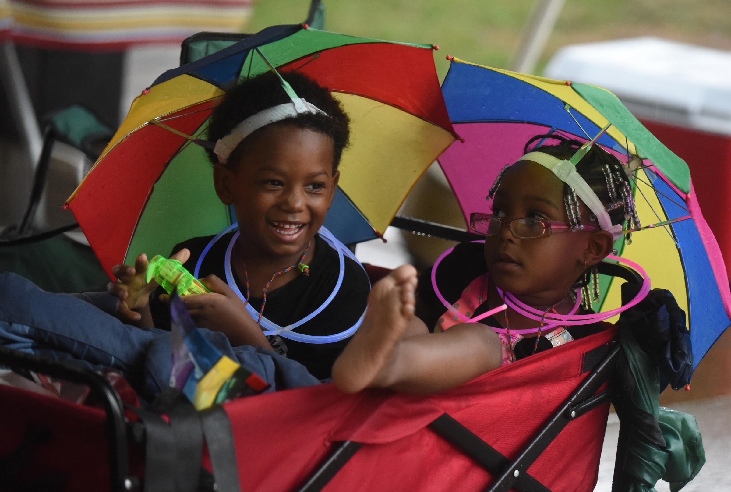 Staff Photo by Angela Lewis Foster/ The Chattanooga Times Free Press- 6/08/15
Four-year-old cousins Emory Shropshire, left, and Jacari Johnson stay dry under a tent and their umbrella hats during a rain storm Monday at the Bessie Smith Strut.